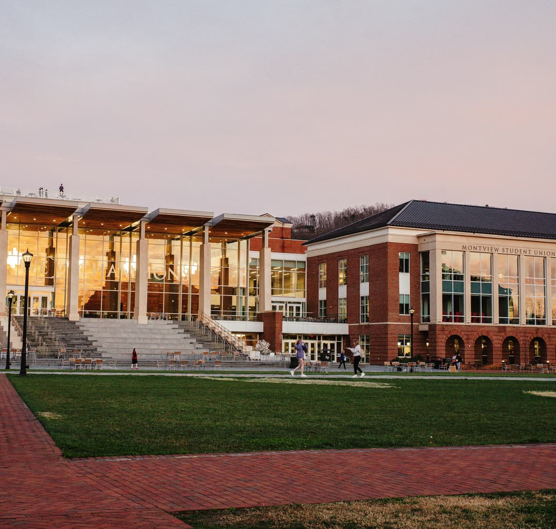 2 female volleyball players celebrate after a won point.